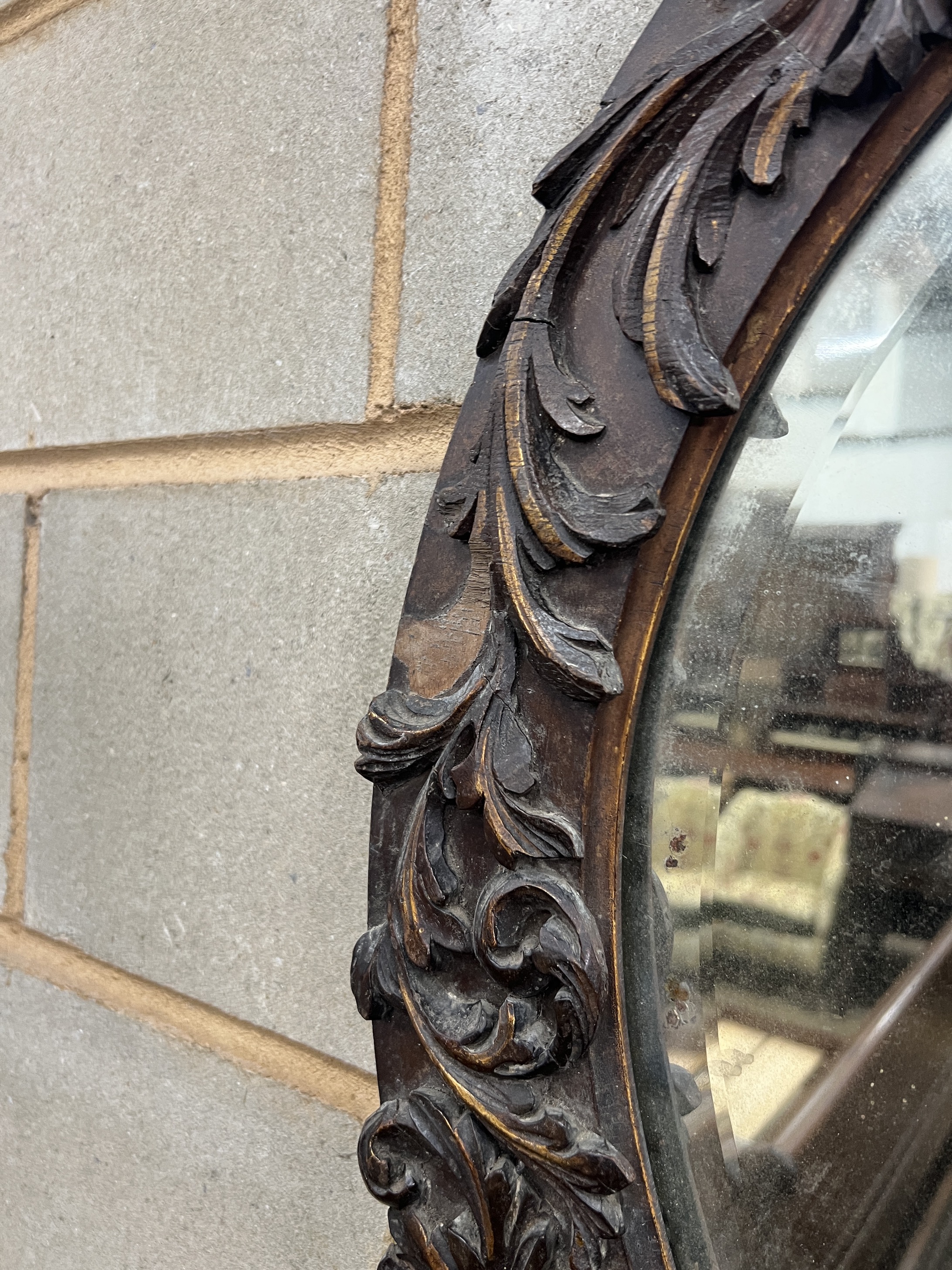 An 18th century style carved wood oval wall mirror, width 57cm, height 67cm